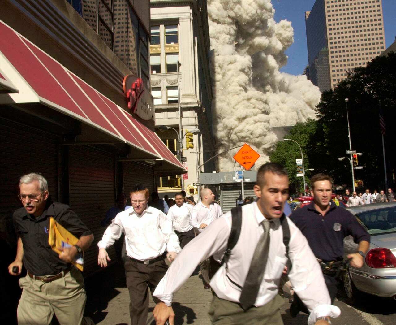 People run from the collapse of World Trade Center Tower  Tuesday, Sept. 11, 2001 in New York. 