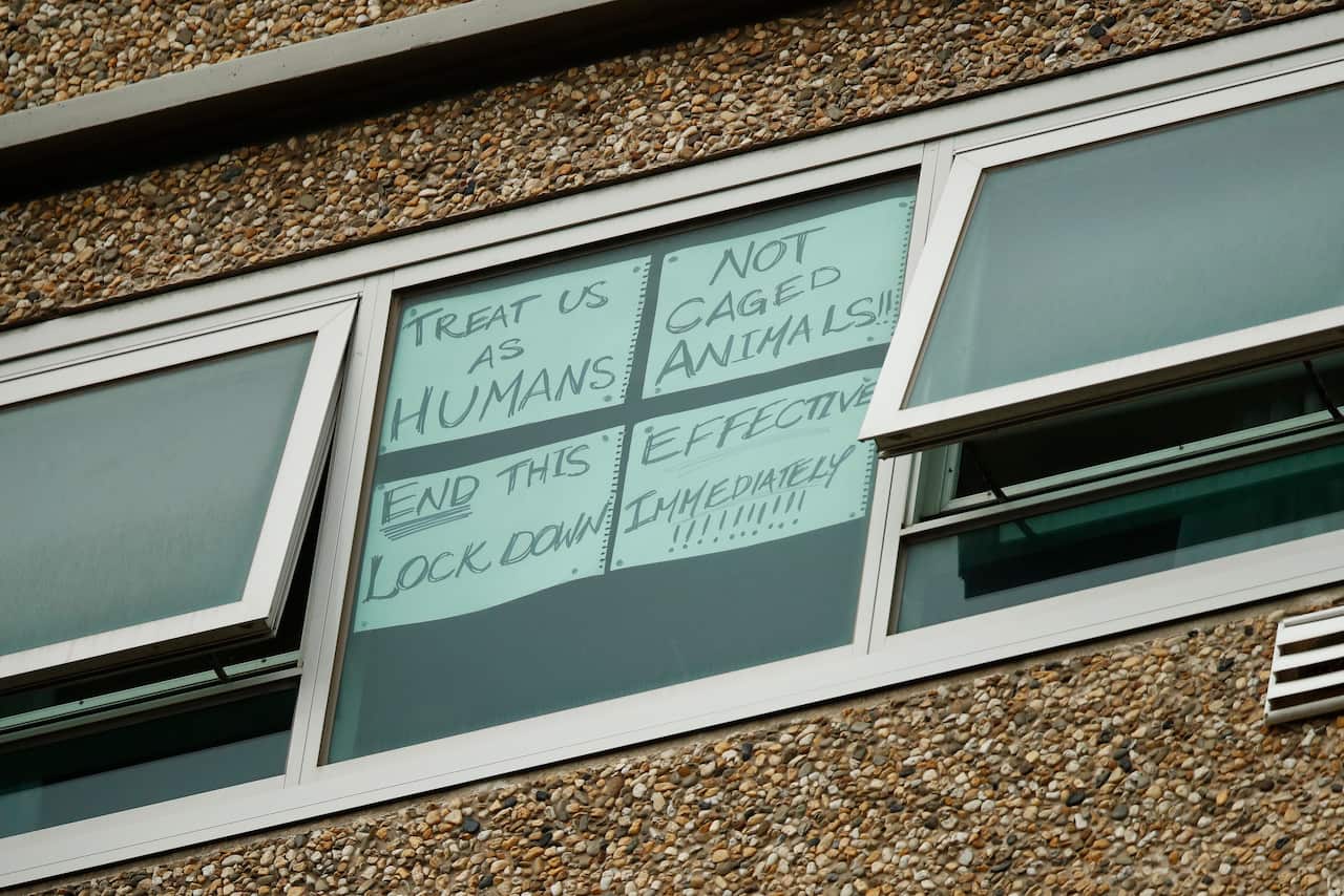 A sign is seen on a window at one of the public housing towers on Racecourse Road in Flemington, Melbourne.