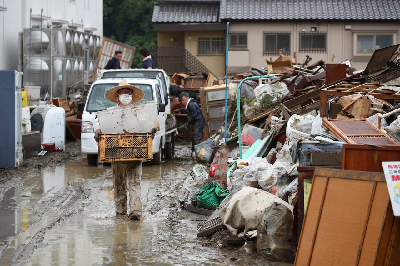Local residents tidy up in Hitoyoshi City, Kumamoto Prefecture.