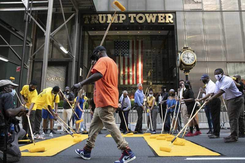 Black Lives Matter is painted on Fifth Avenue in front of Trump Tower, Thursday, July 9, 2020, in New York. (AP Photo/Mark Lennihan)