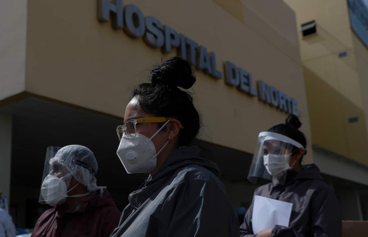 Health workers in full protective gear in El Alto, Bolivia.