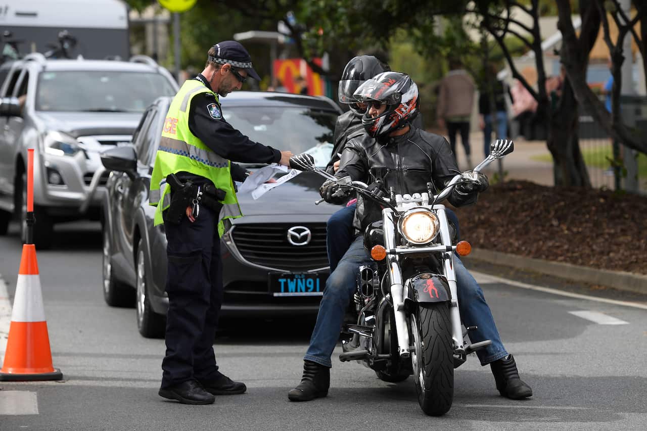 Police stop motorists crossing the Qld-NSW border to check to for permits at Coolangatta on the Gold Coast.