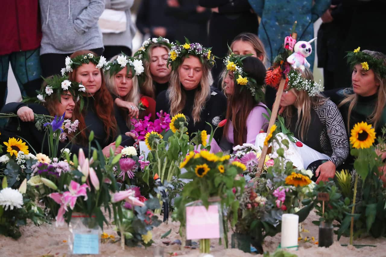 Girlfriend Ellidy Vlug along with friends and family pay their respects at the memorial set up at Palm Beach on the Gold Coast.
