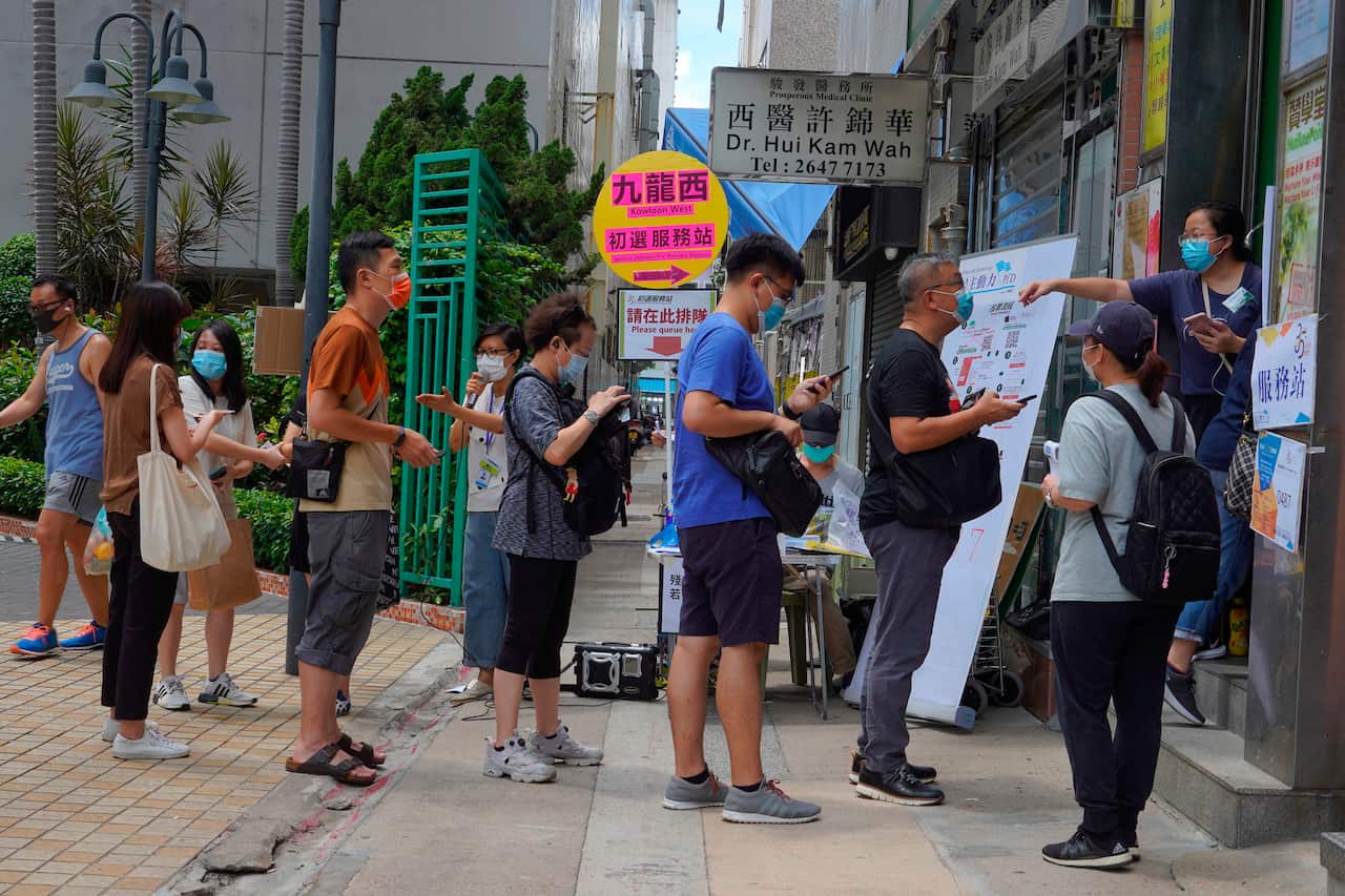 People queue up to vote in Hong Kong in an unofficial primary for pro-democracy candidates ahead of legislative elections in September.
