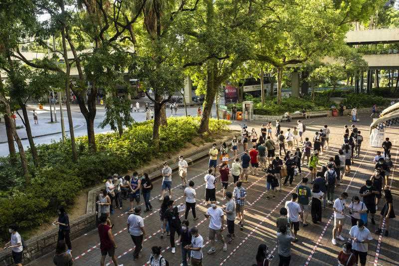 People queue up at a temporary polling station