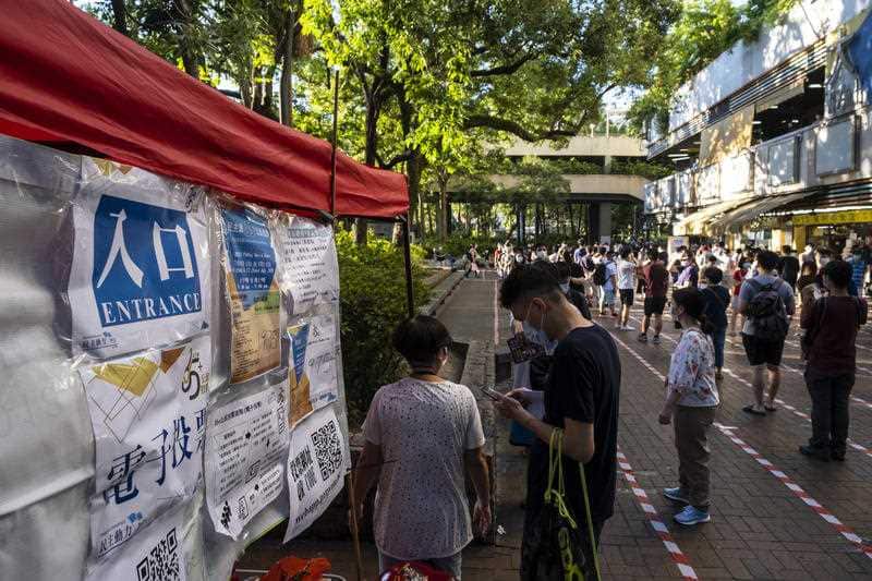 People queue up at a temporary polling statio