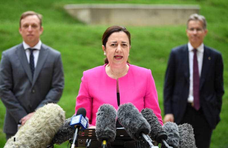 Queensland Premier Annastacia Palaszczuk, flanked by Health Minister Steven Miles (left) and University of Queensland as Vice-Chancellor Peter Høj (right)
