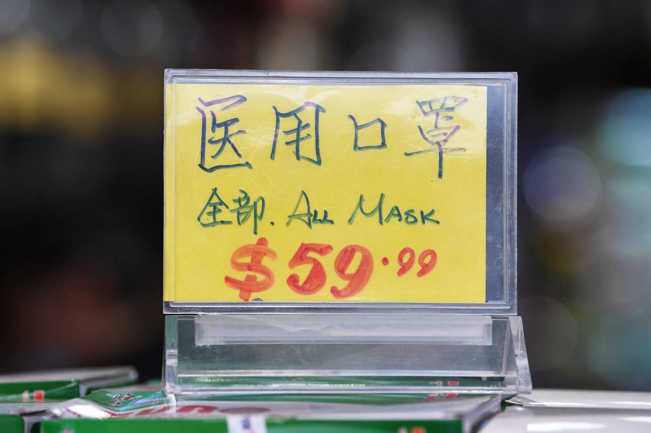 Signage for the cost of facemasks is seen inside a store in Melbourne.