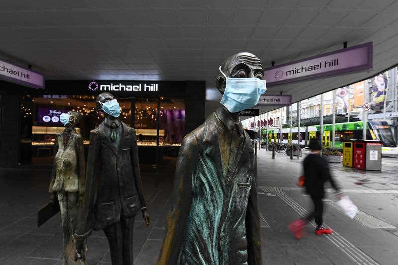 Masks are seen on a statue along Swanston street in Melbourne, Monday, July 20, 2020. 