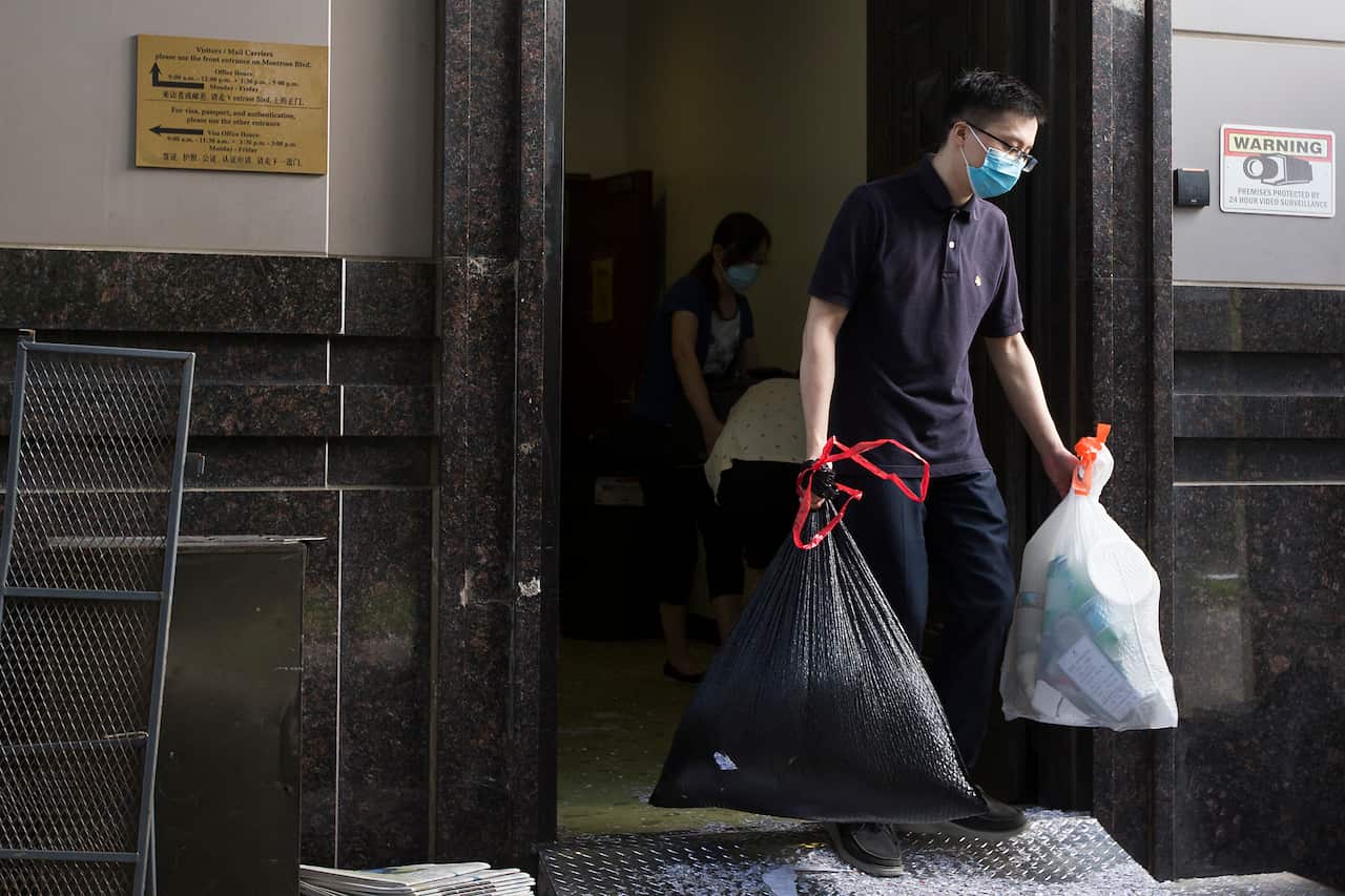 Consulate workers remove items from China's consulate in Houston.