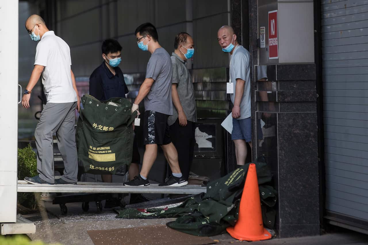 Consulate workers carry diplomatic bags from the Consulate General of China in Houston.