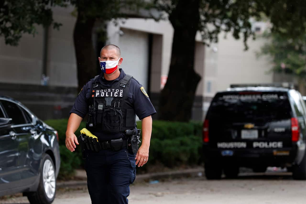 A Houston police officer patrols outside the China Consulate General building.