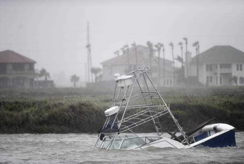 A boat sinks in the Packery Channel during Hurricane Hanna, Saturday, July 25, 2020, in North Padre Island, Texas