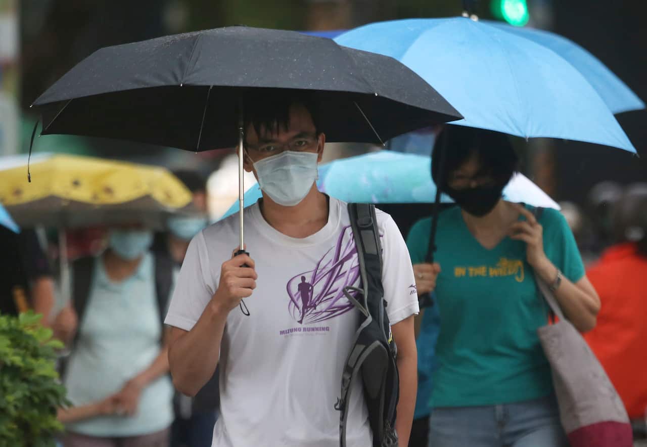 People wear face masks to protect against the spread of the coronavirus in Taipei, Taiwan, Monday, July 27, 2020. (AP Photo/Chiang Ying-ying)