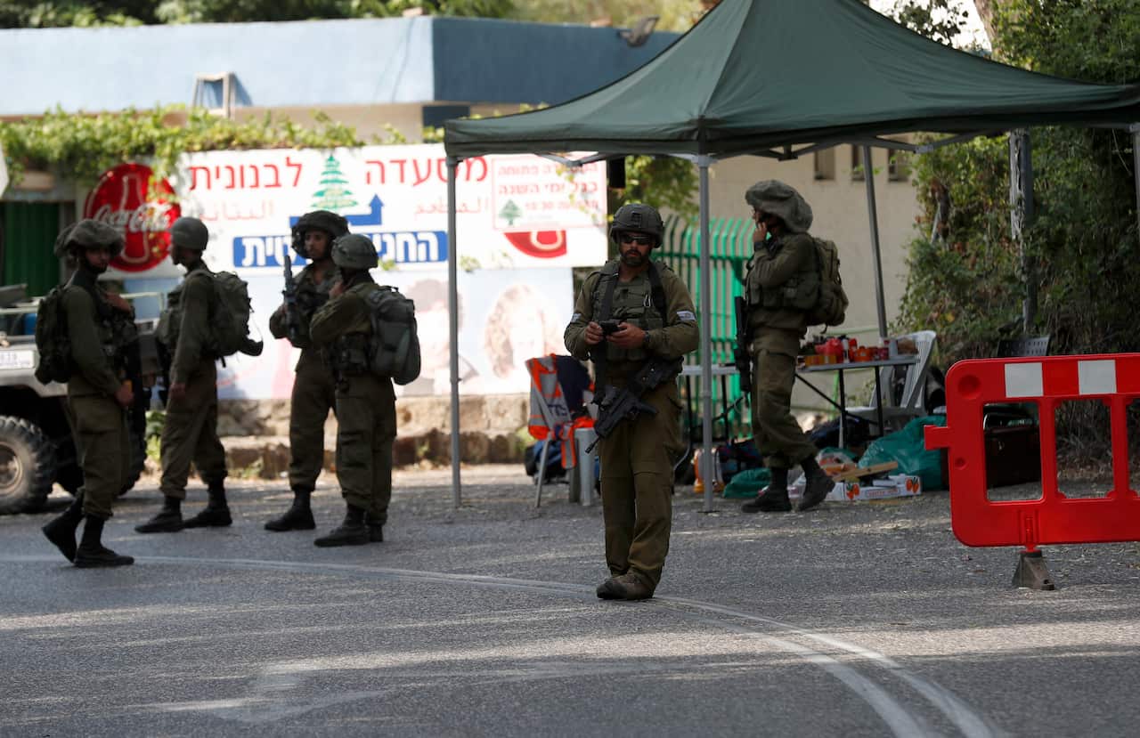 Israeli soldiers block the road leading to Mount Dov area between Israel and Lebanon, near the Lebanese village of Shebaa, 27 July 2020.