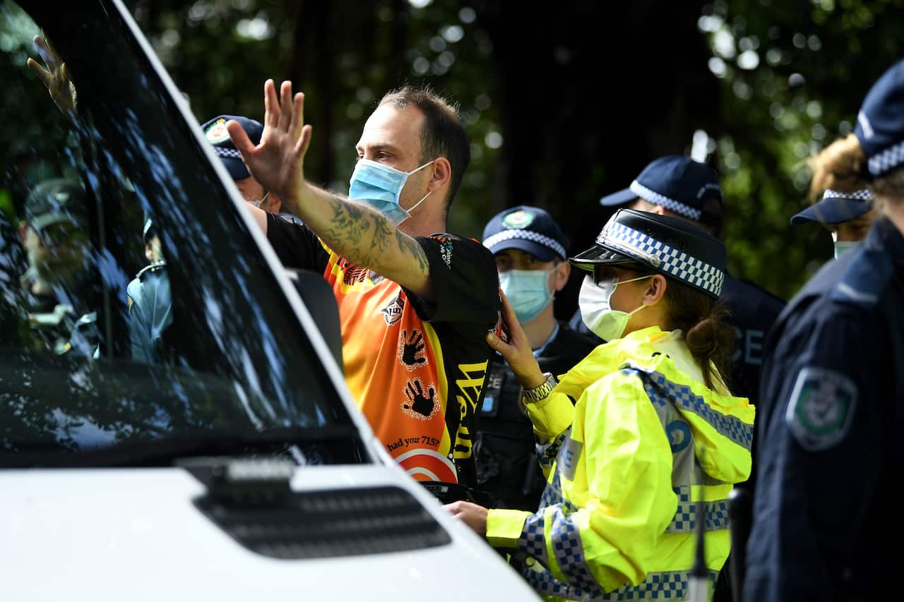 A man is detained by NSW Police during a Black Lives Matter protest in Sydney.