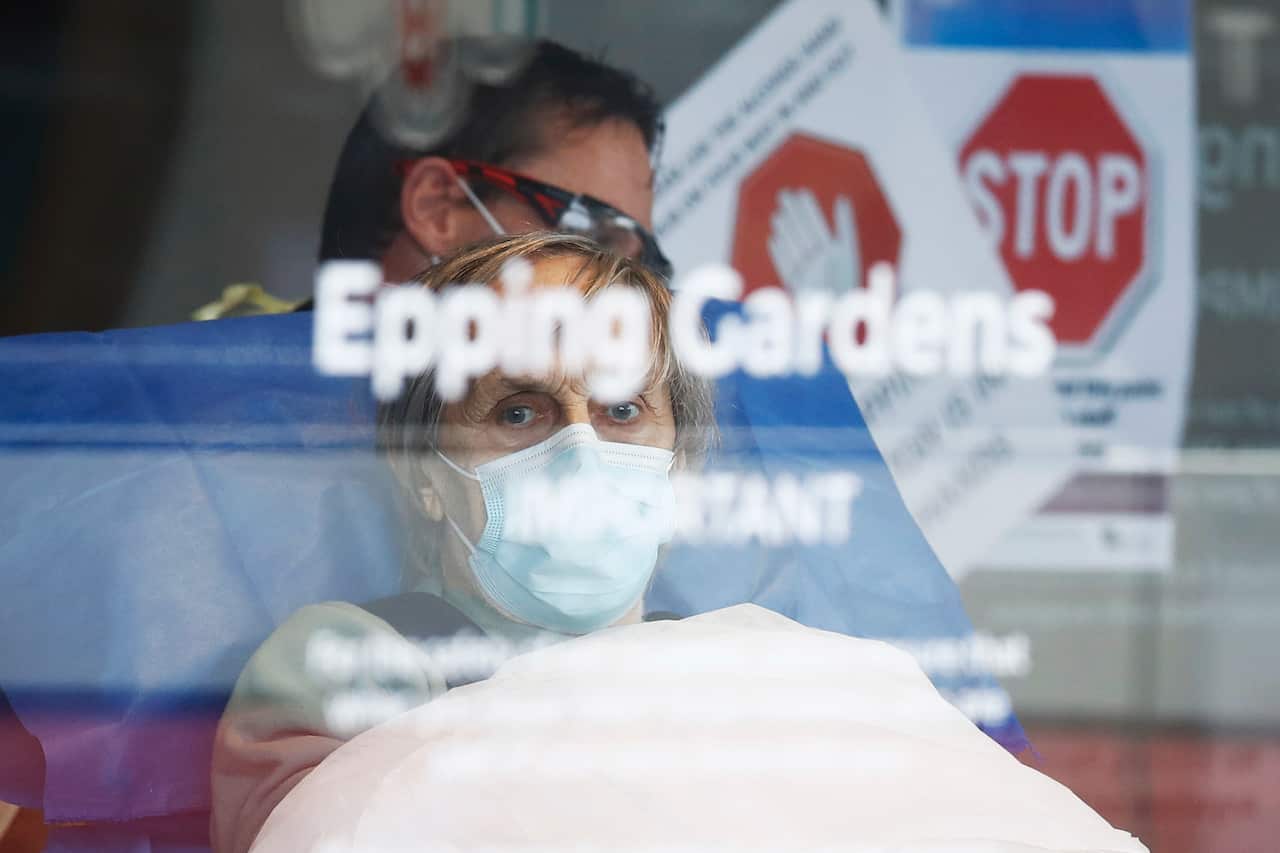 A resident is taken away in an ambulance from Epping Gardens Aged Care Facility in Epping, Melbourne, Tuesday, 28 July, 2020.