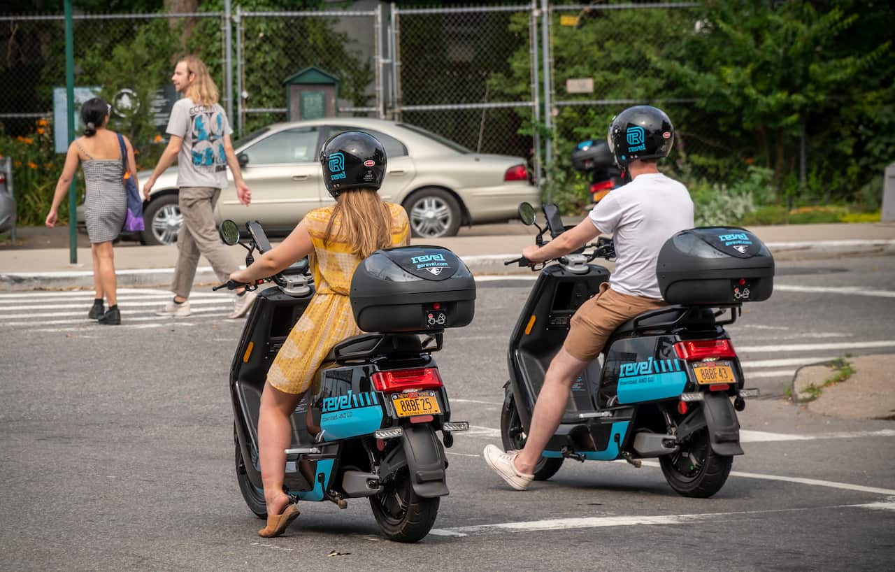 Riders travel on an electric moped from the moped sharing company Revel in the Red Hook neighbourhood of Brooklyn in New York.