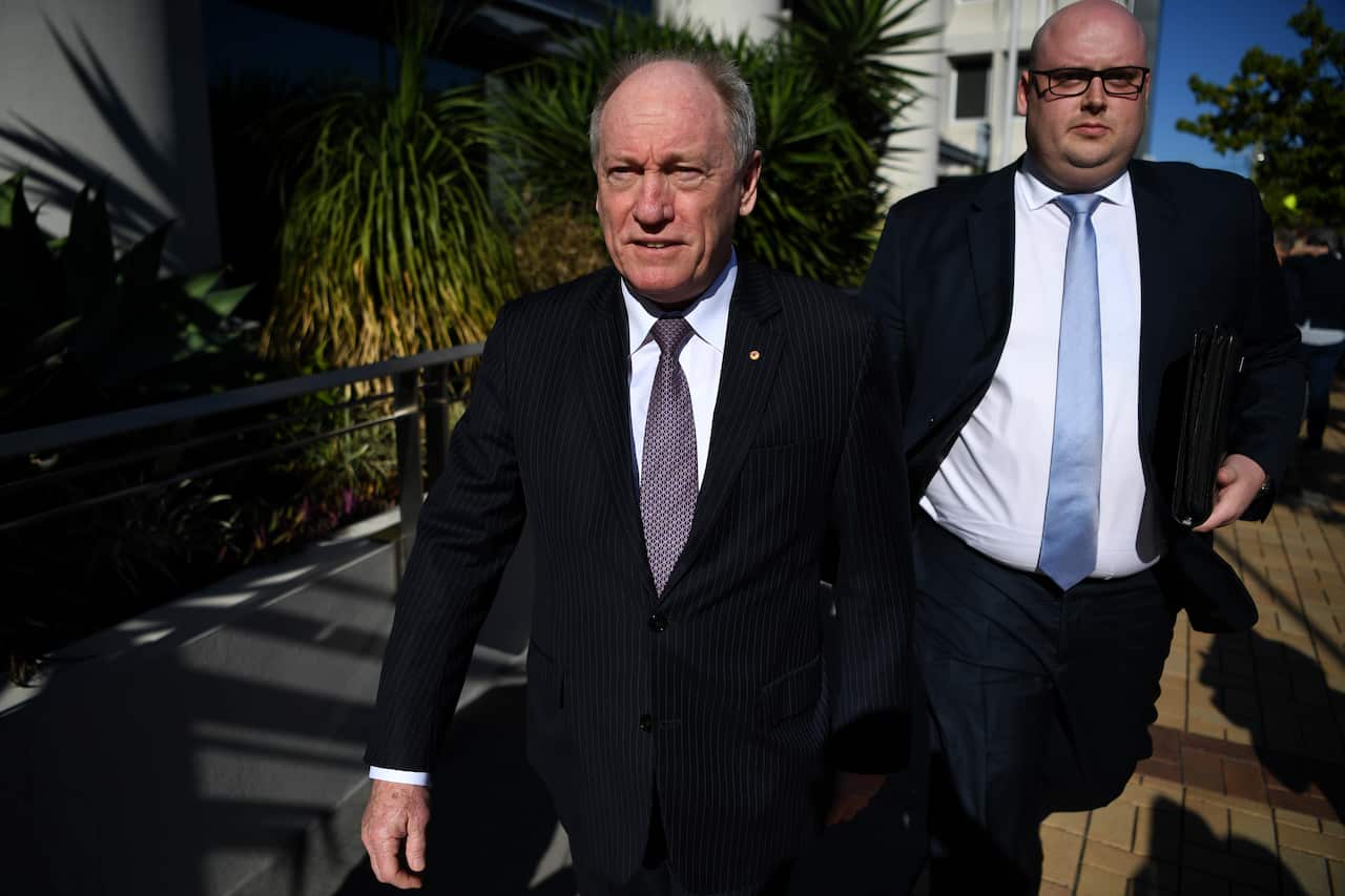 Bruce Hodgkinson (left), a lawyer for Dreamworlds operator Ardent Leisure, leaves the Magistrates Court in Southport on 29 July. 