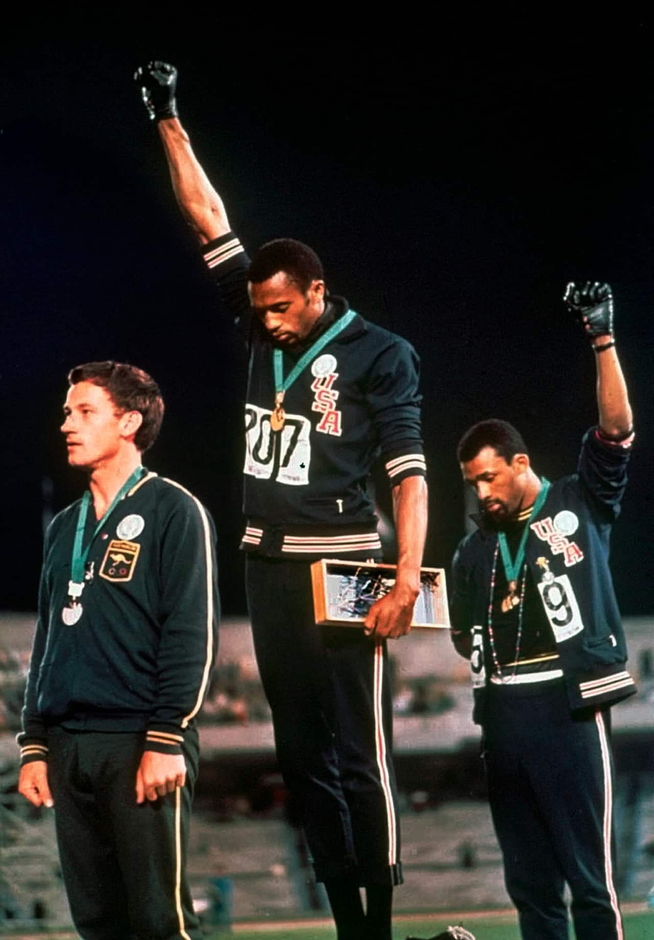 Athletes Tommie Smith and John Carlos protest with a black power salute at the 1968 Olympics in Mexico City.