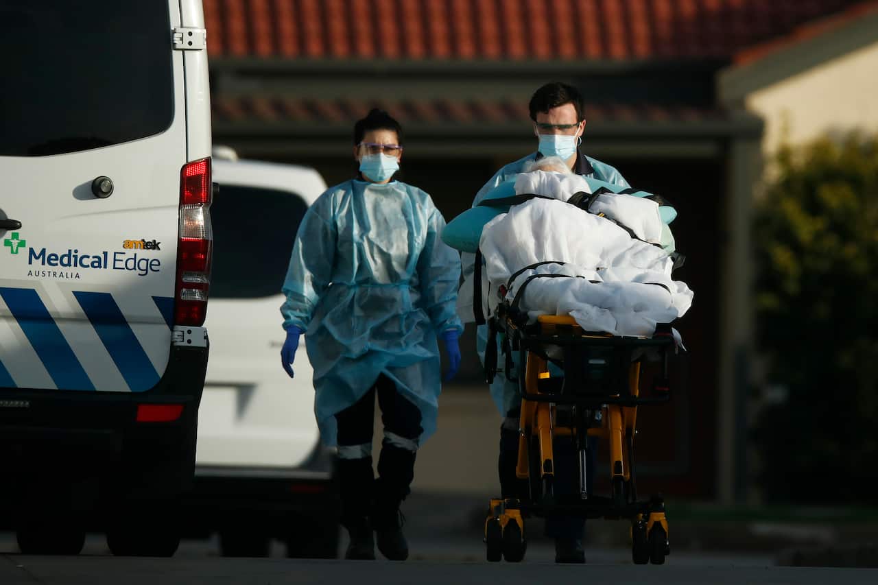 A resident is removed from St Basil's Homes for the Aged in Fawkner, Melbourne, where more than 160 coronavirus cases have been detected. 