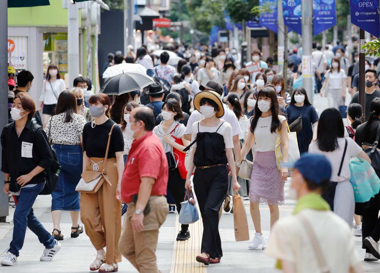 People wearing face masks walk in Tokyo's Ikebukuro area.