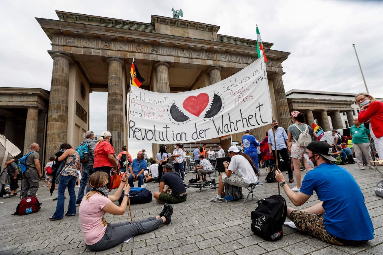 Dozens of demonstrators gather in front of the Brandenburg Gate during a a protest against coronavirus pandemic regulations in Berlin.