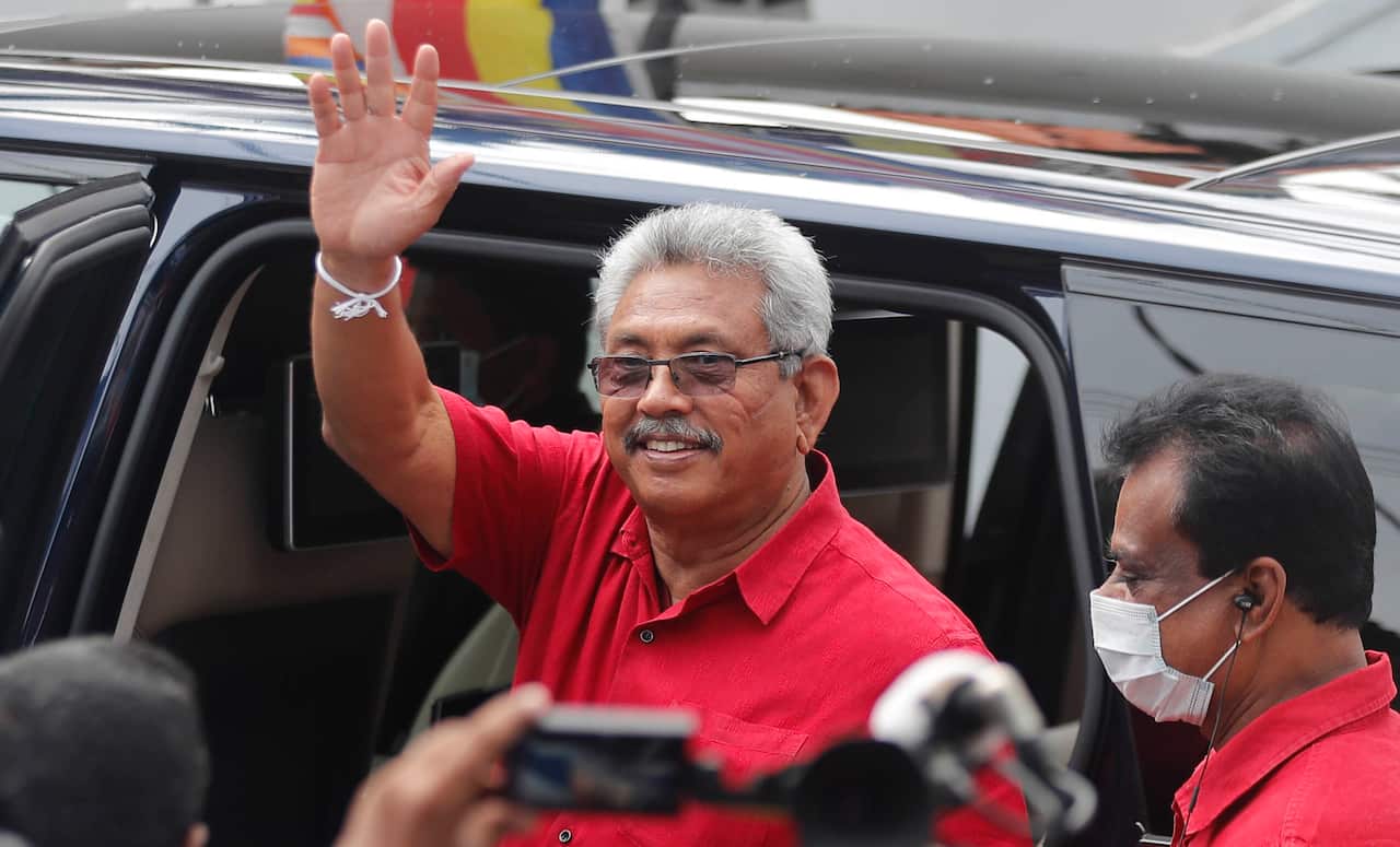 Sri Lankan president Gotabaya Rajapaksa waves after casting his vote during the parliamentary election in Colombo, Sri Lanka