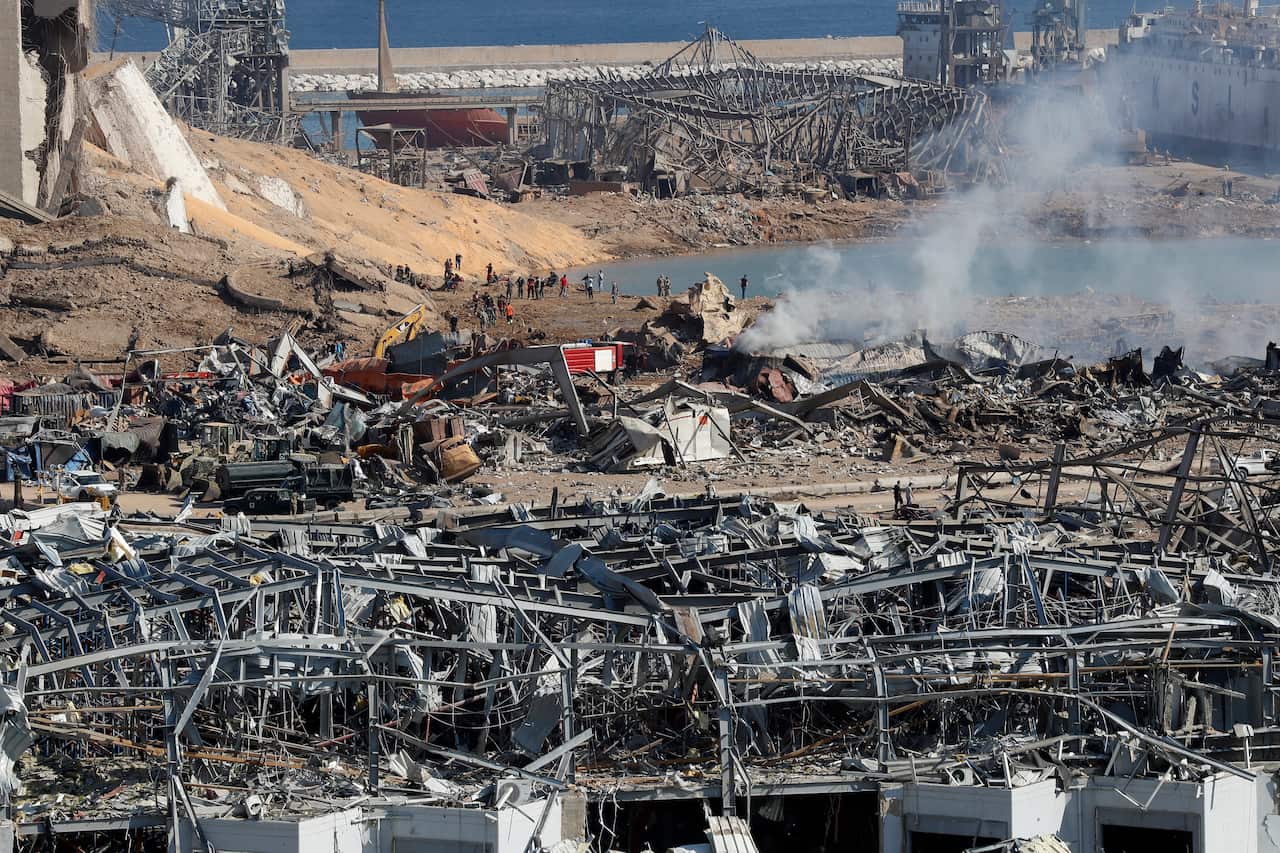 Rescue workers and security officers work at the scene of an explosion that hit the seaport of Beirut, Lebanon.