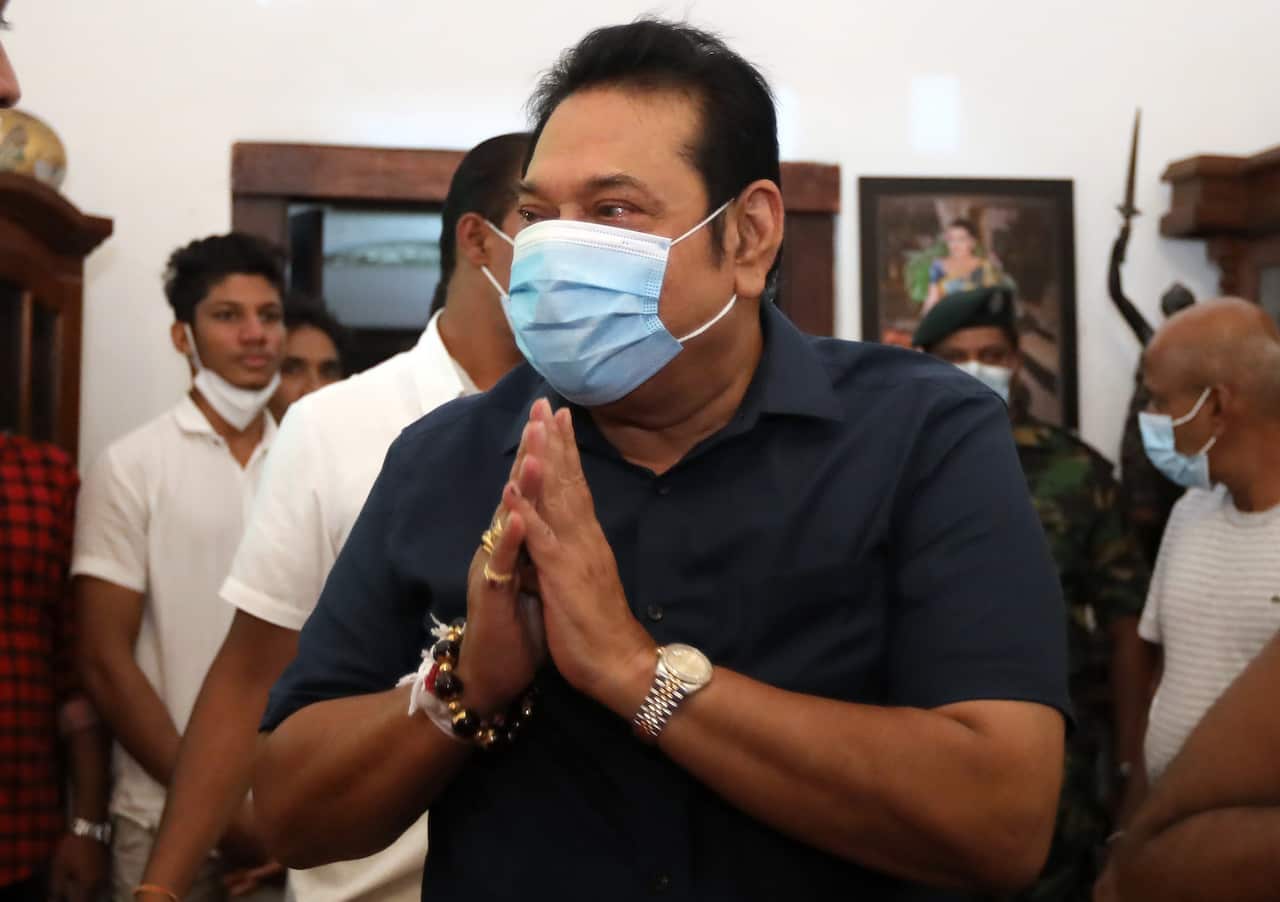 Sri Lankan Prime Minister elect Mahinda Rajapaksa greets people at his home in Beliatta, Hambantota.