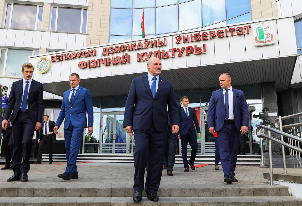 Belarus' Incumbent President Alexander Lukashenko leaves after voting in the 2020 Belarusian presidential election at a polling station.