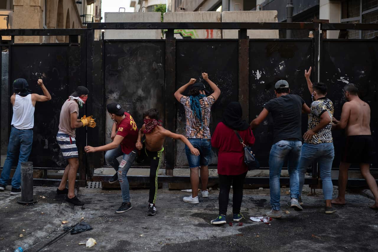Demonstrators hit a barrier erected to prevent them reaching the Parliament building.