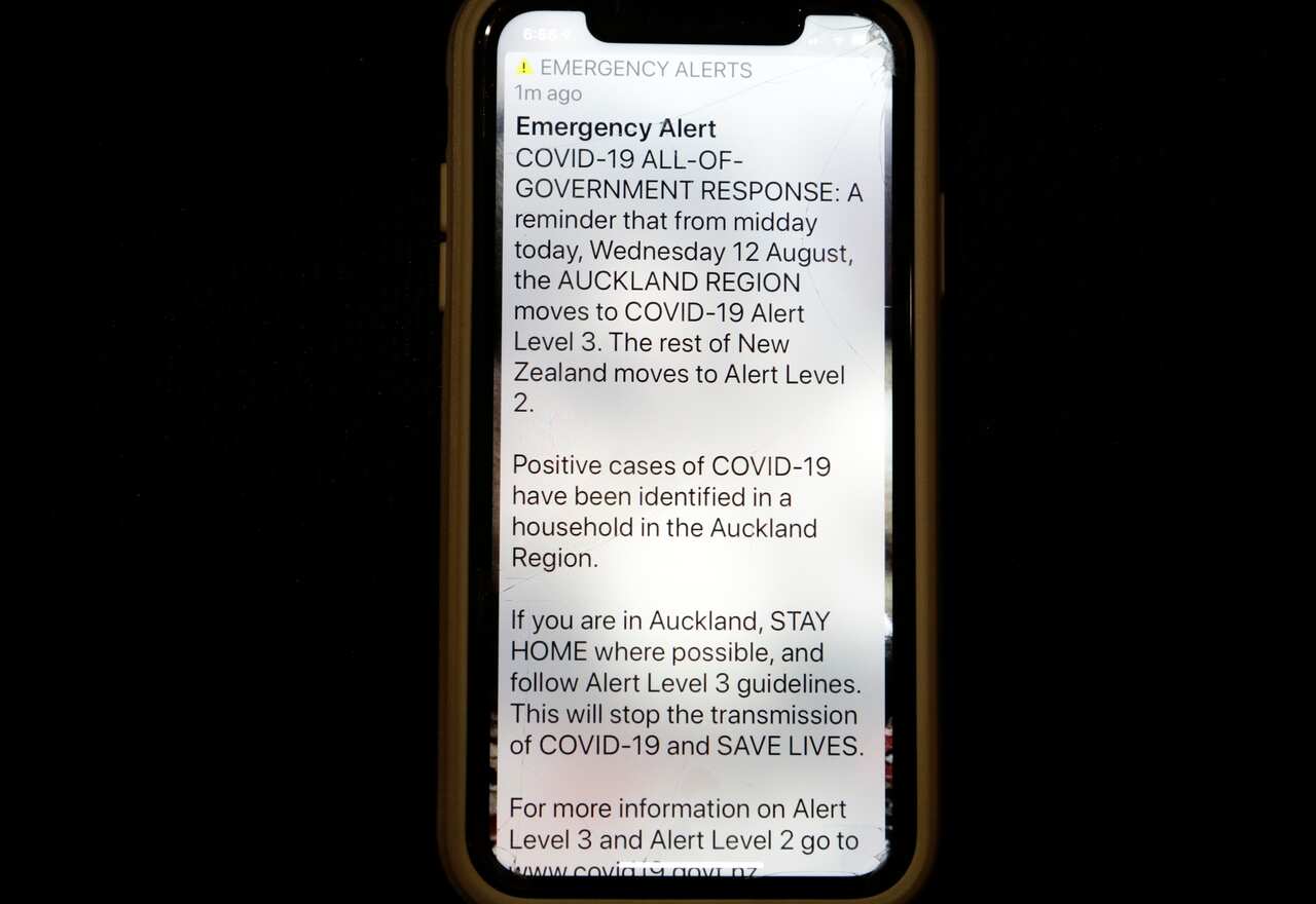 A news alert is displayed on a mobile phone in Christchurch, New Zealand, Wednesday, 12 August, 2020. 