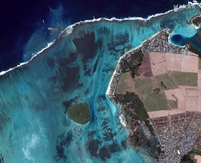 A handout satellite image made available by MAXAR Technologies shows the MV Wakashio leaking oil 