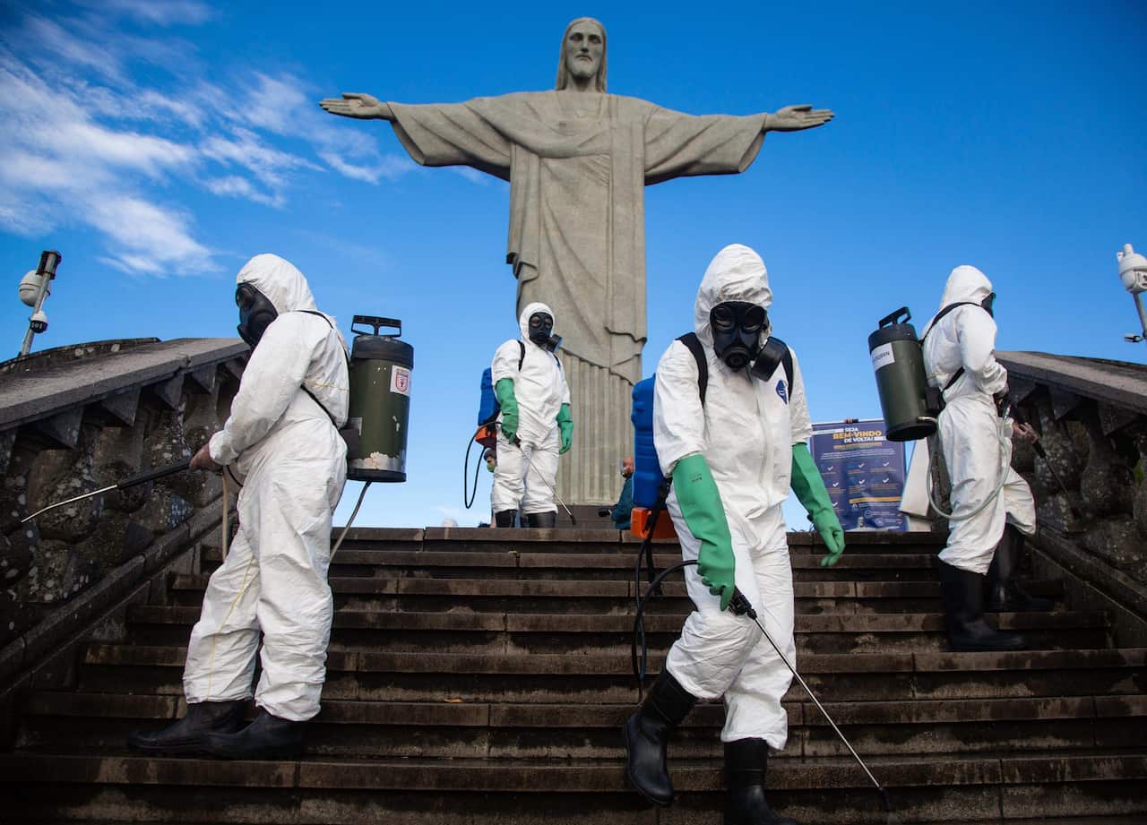 Soldiers of the Brazilian army disinfect the Cristo Redentor monument to reopen the tourist spot, in Rio de Janeiro, Brazil on 13 August.