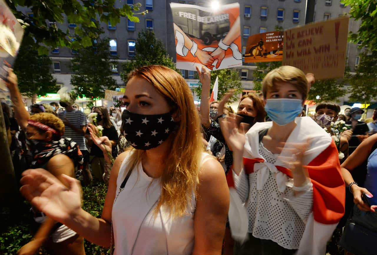 People demonstrate in support of Belarus protesters in Warsaw, Poland, on 13 August.