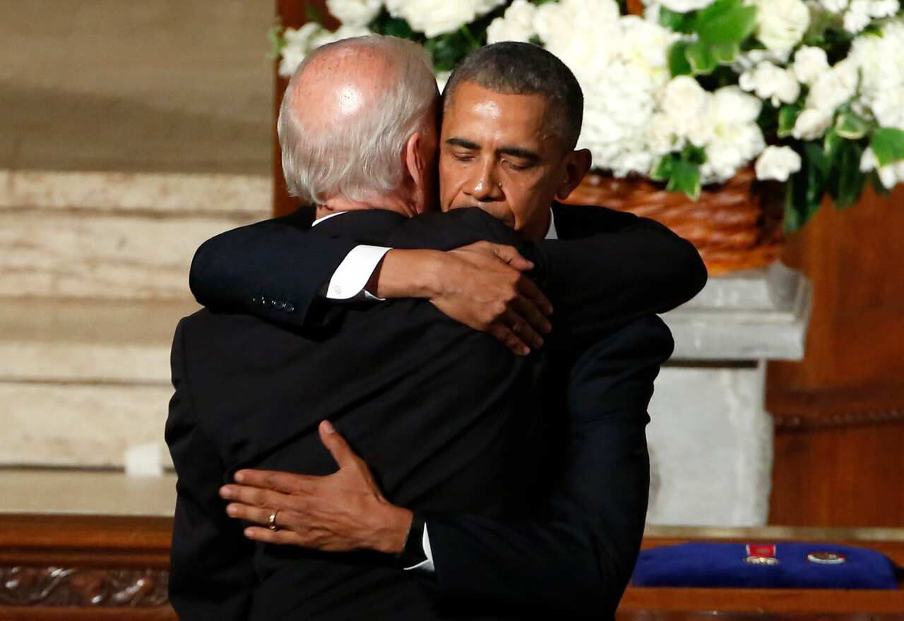 FILE - In this June 6, 2015, file photo, then=President Barack Obama hugs then-Vice President Joe Biden during funeral services for Biden's son, Beau Biden, at St. Anthony of Padua Church in Wilmington, Del. (Yuri Gripas/Pool Photo via AP, File)