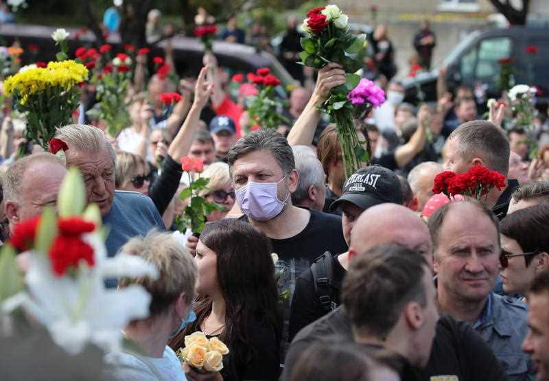 People attend a funeral ceremony for Alexander Tarakhovsky, in Minsk, Belarus, 15 August 2020. 