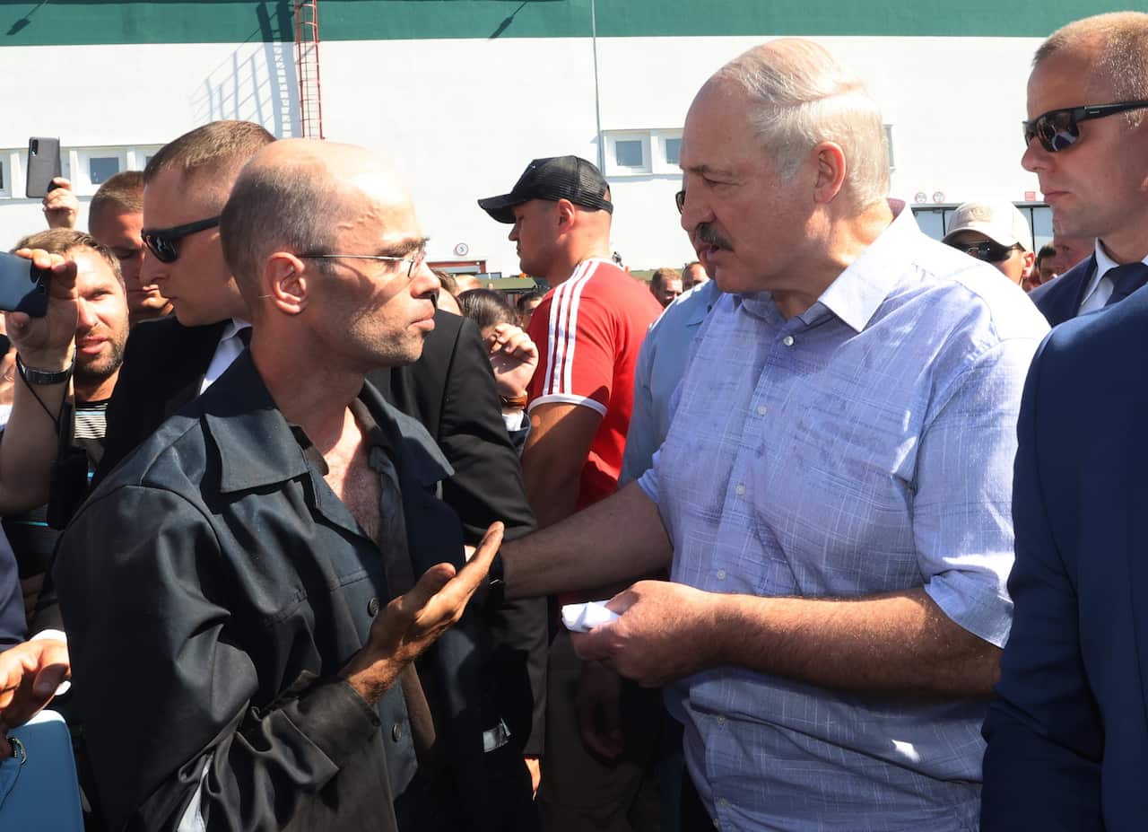 Belarus president-elect Alexander Lukashenko speaks to a worker as he visits the Minsk Wheeled Tractor Plant in Minsk, Belarus.