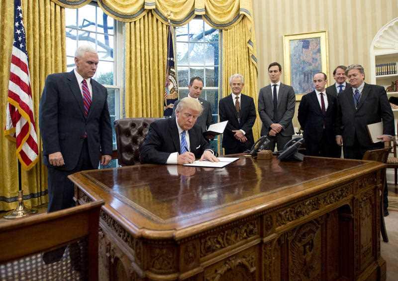  President Donald Trump signs the first of three Executive Orders in the Oval Office in January 2017. 