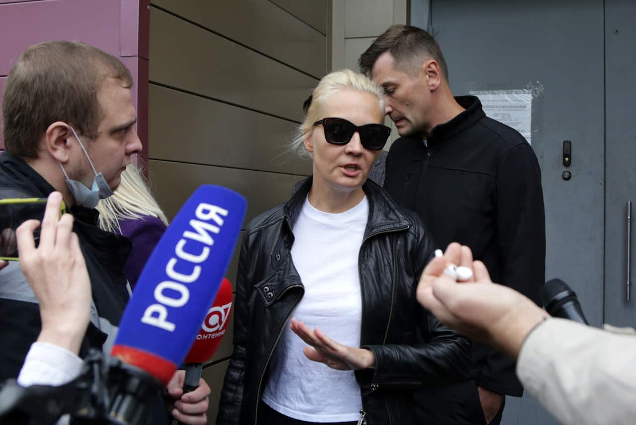 Alexei Navalny's wife Yuliya talks to journalists outside the Siberian hospital where he is staying. 