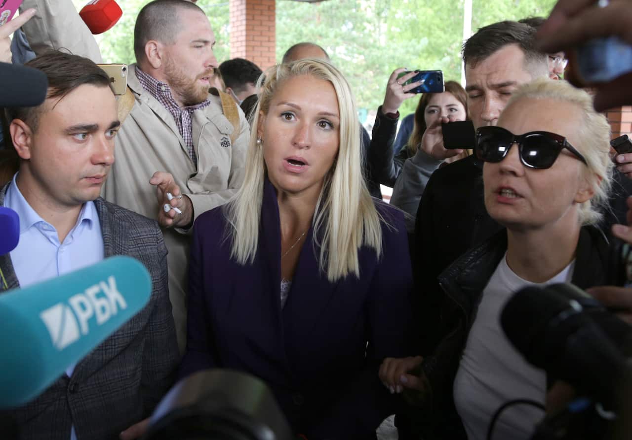 Anti-Corruption Foundation head Ivan Zhdanov, Alexei Navalny's doctor Anastasia Vasilyeva and his wife Yuliya talk speak to reporters outside the hospital.