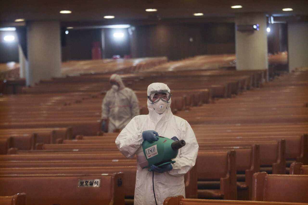 Public officials disinfect as a precaution against the coronavirus in Seoul, South Korea.
