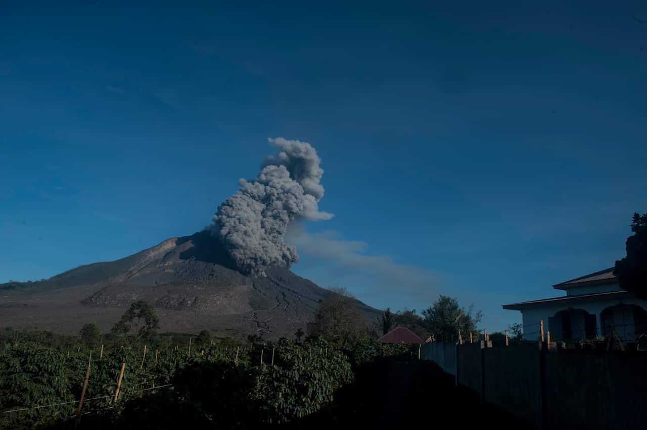 Sinabung volcano is seen spewing giant hot clouds into the air as eruptive activity.