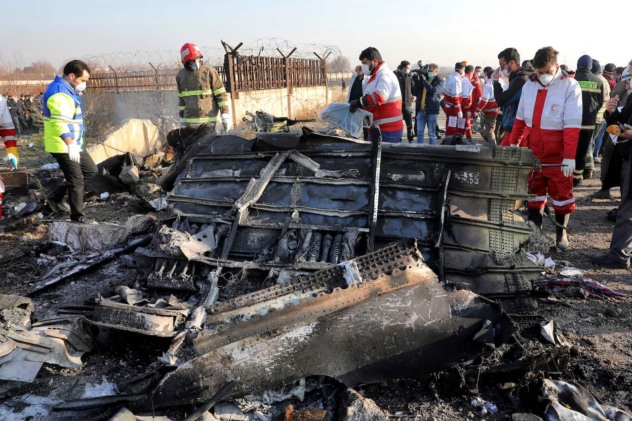 Rescue workers search the scene where an Ukrainian plane was shot down in Shahedshahr, southwest of the capital Tehran, Iran.