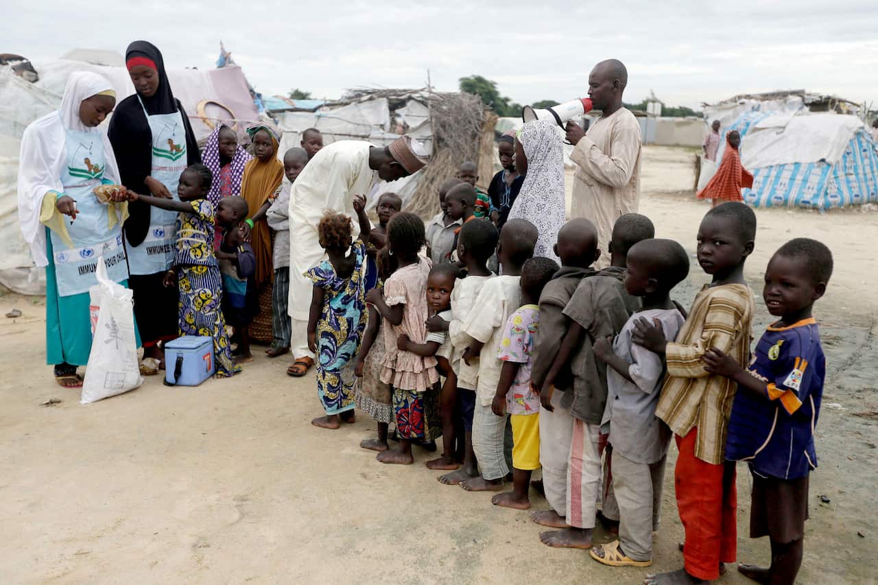 A file photo of health officials administering polio vaccine to children at a camp for people displaced by Islamist extremists in Maiduguri, Nigeria. 