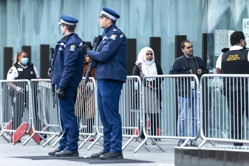 Victims and relatives wait to enter the Christchurch High Court for the final day in the sentencing hearing for the Australian gunman. 