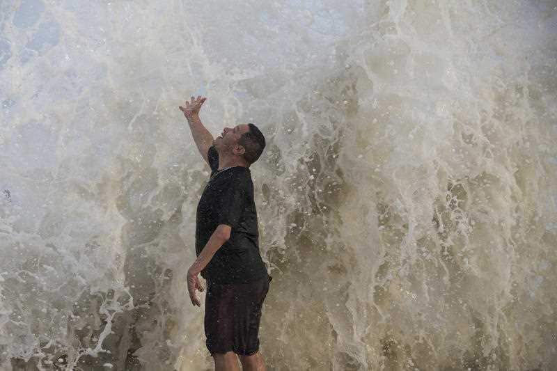 A man watching the surf stirred up by Hurricane Laura Wednesday, Aug. 26, 2020 in Galveston, Texas.