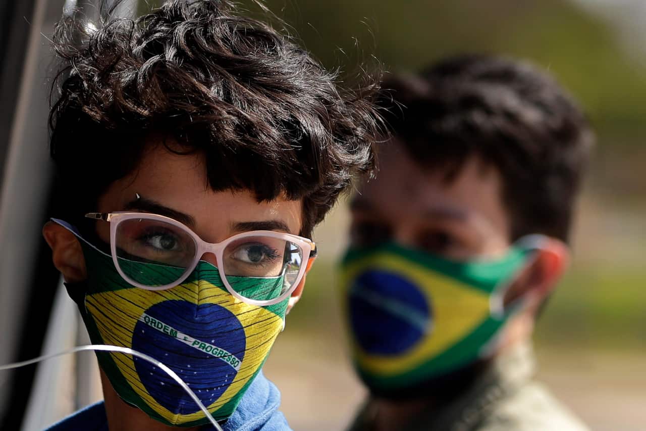 Protesters wear masks amid the COVID-19 pandemic in Brasilia, Brazil.
