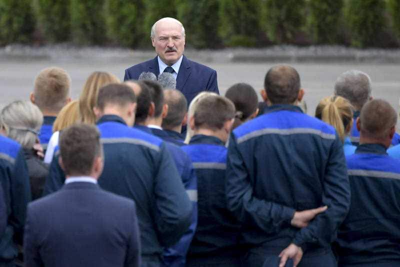 Belarusian President Alexander Lukashenko gestures while addressing employees of the Orsha dairy plant in Orsha.